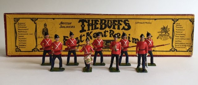 Britains Set #16 East Kent Regiment: Pre War. In original Whisstock Box. Figures with mustaches. 9 Pieces. Condition Figures Very Good; 3 Figures missing helmet spikes. Condition Box Excellent; Missing tie card.