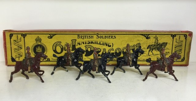 Britains Set #108 6th Inniskilling Dragoons: Pre War. In original Whisstock Box. 5 Pieces. Condition Figures Good; With chipping. Condition Box Very Good; With tape repairs, embellishments and incorrect Post War Bottom.