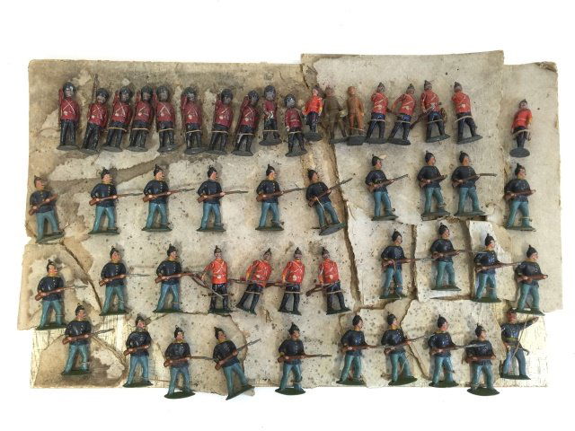 Assortment of Early American & English Figures: Pre War. Circa Early 1900s. 50 Pieces. American Soldier and Britains Figures. Condition Very Good; With numerous blemishes, missing rifle tips, board stained etc.