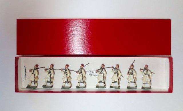 Britains Set #196 Greek Evzones: 8 pieces. Moveable arms. Post War. Tied on original card in red craft box. Condition very good. Box very good.