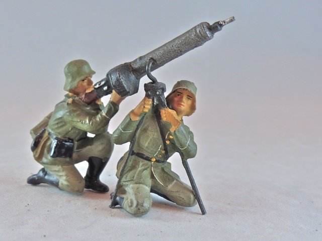Lineol 2 German Soldiers w/Lt Machine Gun: No cracks or apparent wear. Excellent faces, paint quality and gun detail. The soldier supporting the gun can be rotated around to assume different positions. I Piece. Made ONLY 1938-39. Condition Exc
