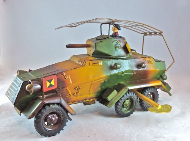 Lineol 6-Wheel Recon. Car w/Antenna: Car is complete with Panzer driver, original antenna, 2 standards and a key. The clockwork motor runs well. As car moves across floor the turret rotates from left/right. Doors open for access to littl