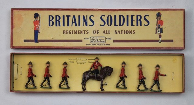 Britains Set #1554 Royal Canadian Mounted Police: Royal Canadian Mounted Police Dismounted in Summer Dress. Post War 1946-59. 7 pieces. Condition: figures mint tied-in-box, Box excellent.
