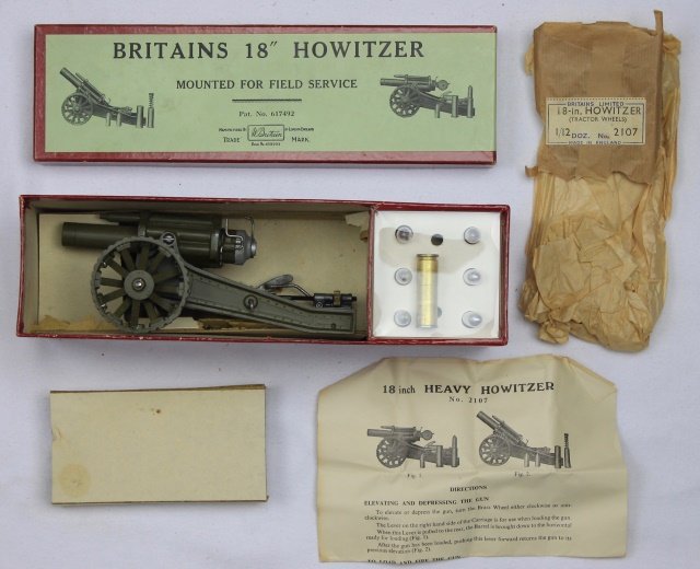 Britains Set #2107 Heavy Howitzer Tractor Wheels: Heavy Howitzer with Tractor Wheels. Post War 1955-66. 1 piece plus all small accessories. Condition: gun mint-in-box, Box very good to excellent. Some interior partitions in box damaged.