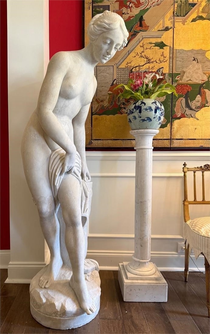 Life size 19th c Italian Marble Venus after Bath: 19th century carved marble nude sculpture after Etienne Maurice Falconet (France 1716-1791) titled 'Venus After the Bath' depicts a goddess in a contrapposto stance with a garment at her waist. She is