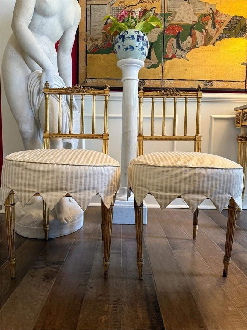 Pair Louis XVI Style Gilt Side Chairs: Pair of 19th century Louis XVI style giltwood side chairs with upholstered seats and fluted legs. Striped annd scalloped seat covers. Elegant classical design.Good overall condition with minor wear to