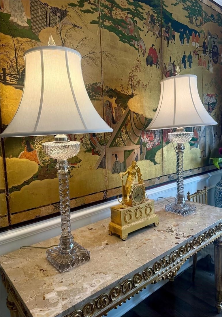 Pair of Paul Hansen Baccarat Style Table Lamps: Elegant pair of crystal table lamps by Paul Hansen New York featuring spiral-twist column stems, molded crystal bases, and faceted crystal finials. Retaining tailored bell-form shades, these lamps