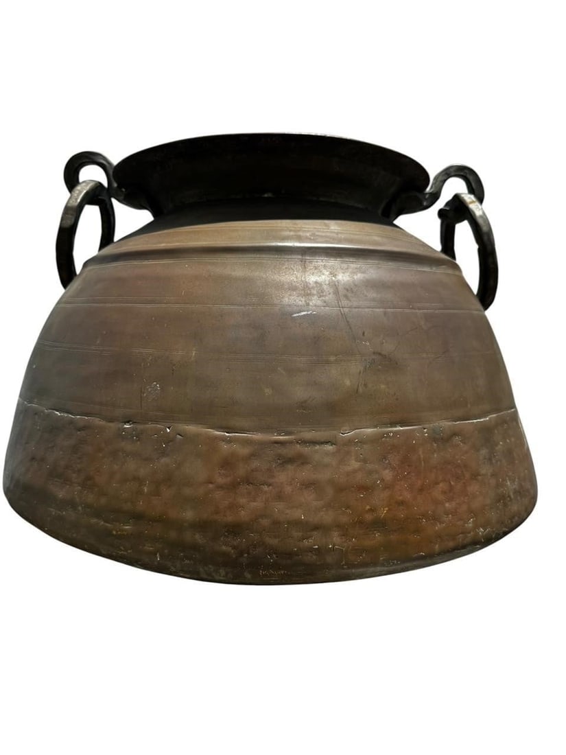 Large solid Bronze Indian Urn Jardiniere: Massive heavy solid bronze early 20th century Indian or Southeast Asian bronze tripod base double handle urn form jardiniere / vessel with holes at base for drainage. Rounded form featuring applied ri