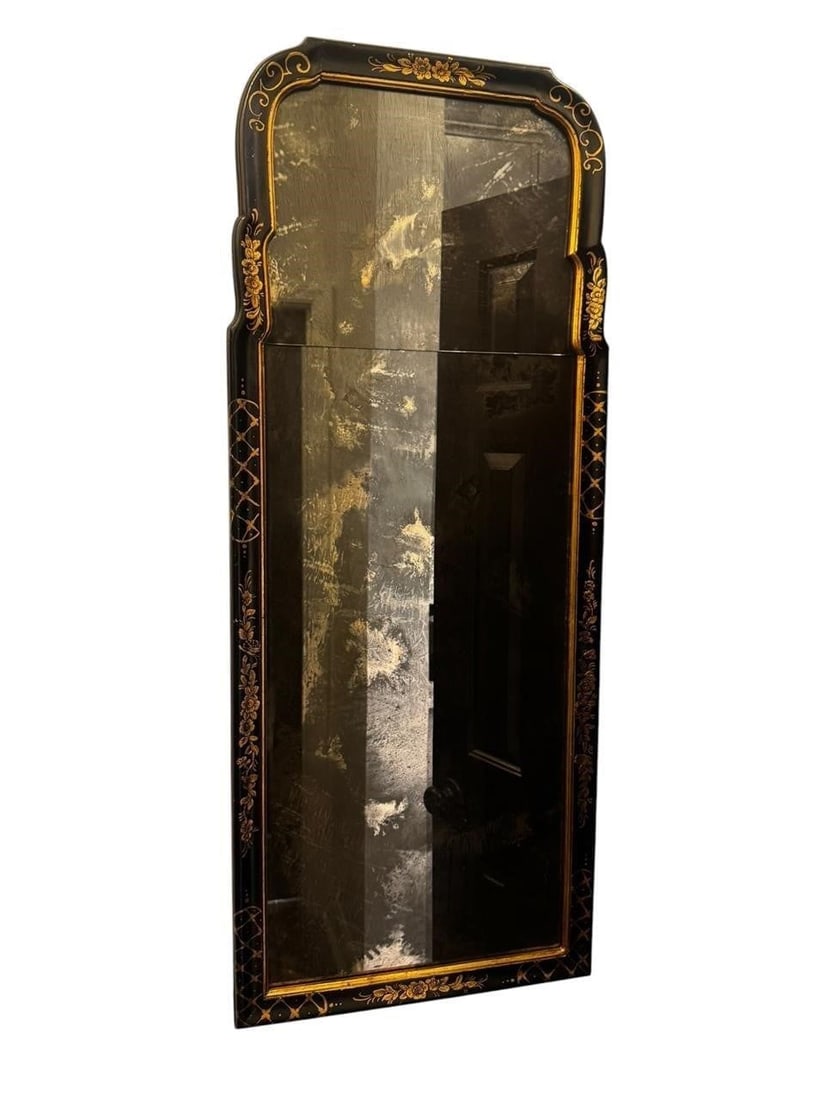 Chinoiserie Queen Anne Style Mirror: Early 20th century Queen Anne style mirror featuring a black Chinoiserie painted frame with gilt floral decoration and an elegant arched crest. Retaining its original divided mirror plates, the refine