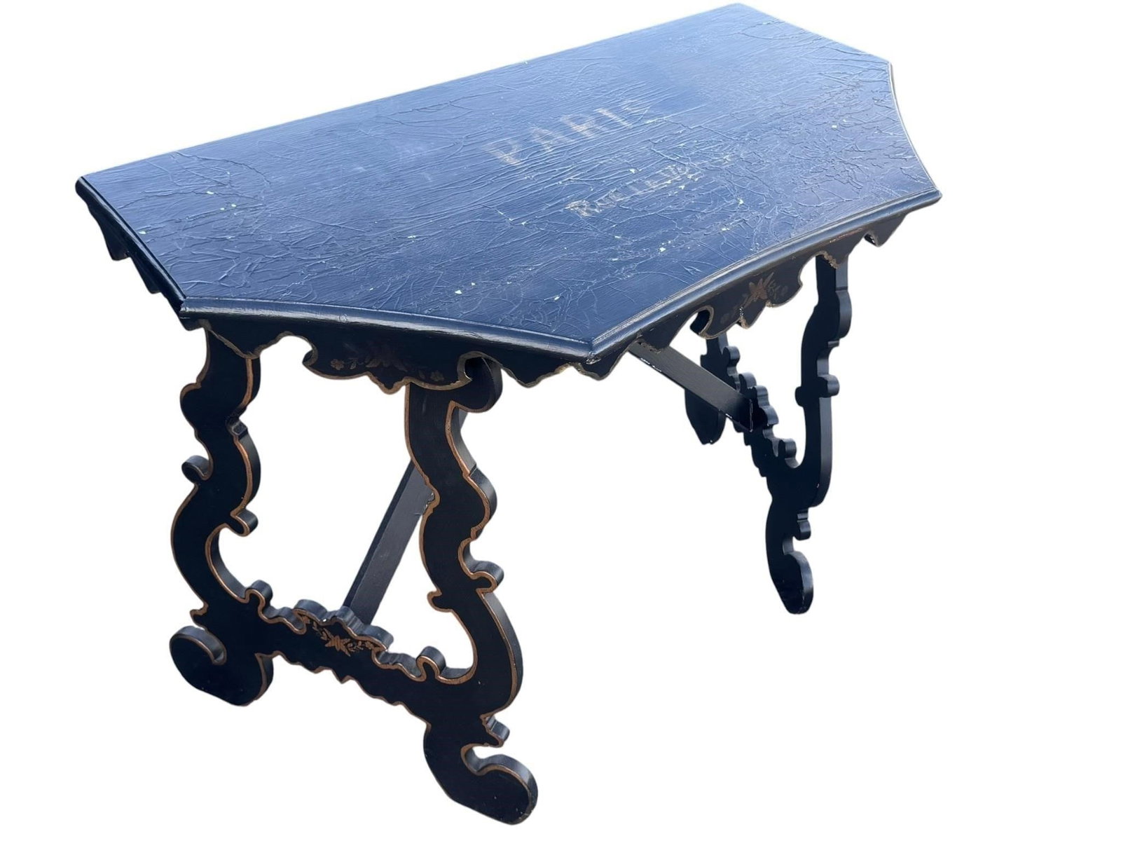 Vintage Ebonized Baroque Style Console Table: Ebonized console table in the Baroque taste featuring boldly scrolled supports, a trestle stretcher, scalloped apron, and hand-painted decorated top. The dramatic silhouette and carved details create