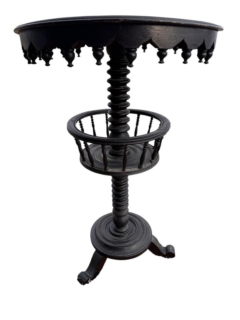 Victorian Pedestal Table: Victorian ebonized pedestal table featuring a turned central standard, scalloped apron, circular lower gallery, and tripod base. An attractive decorative form retaining its period character.28"H x