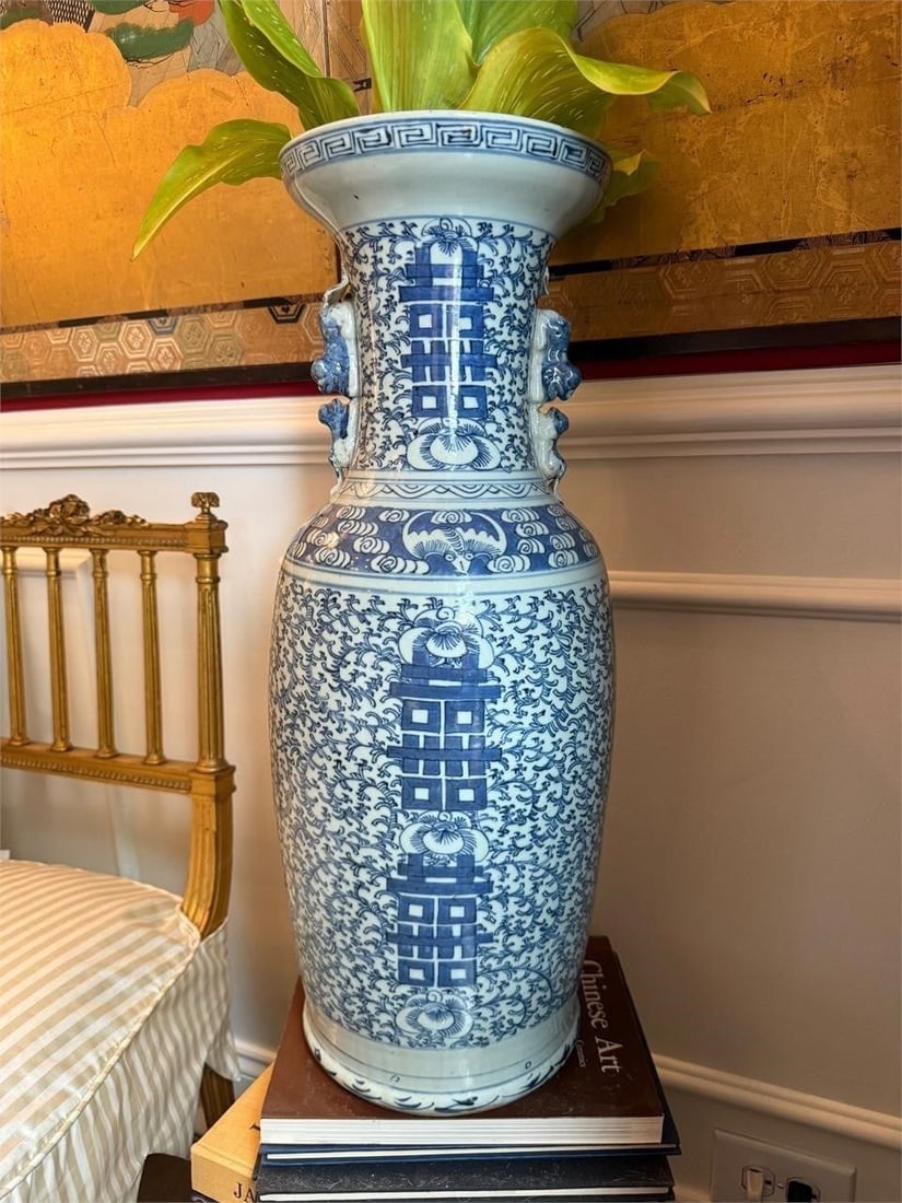 Large Chinese Blue & White Porcelain Vase: Large blue and white porcelain floor vase decorated with stylized longevity symbols and scrolling floral motifs. The neck is flanked by applied figural handles.One applied figural handle with losses