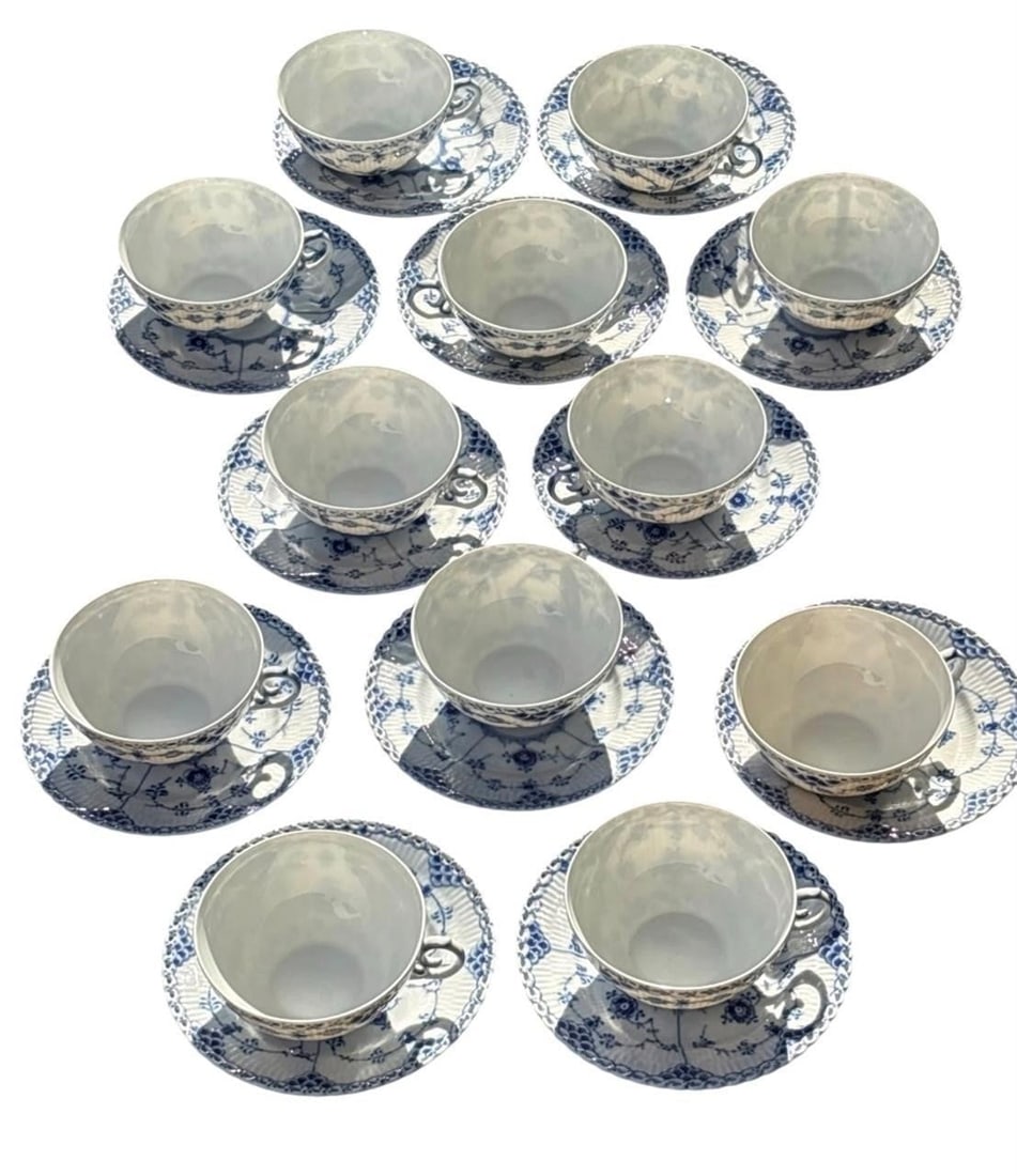 Set of 12 Royal Copenhagen Teacups: Fine set of twelve Royal Copenhagen Blue Fluted porcelain teacups and matching saucers, Denmark. Featuring the iconic hand-painted cobalt blue floral decoration with fluted bodies and pierced borders.