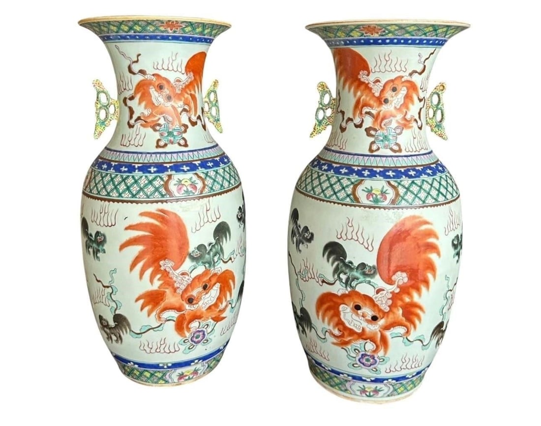 Chinese Famille Rose Foo Dog Porcelain Urns: Pair of late 19th to early 20th century Chinese porcelain urns decorated in the Famille Rose palette with stylized Foo Dogs and traditional auspicious motifs. Elegant baluster forms with applied mask