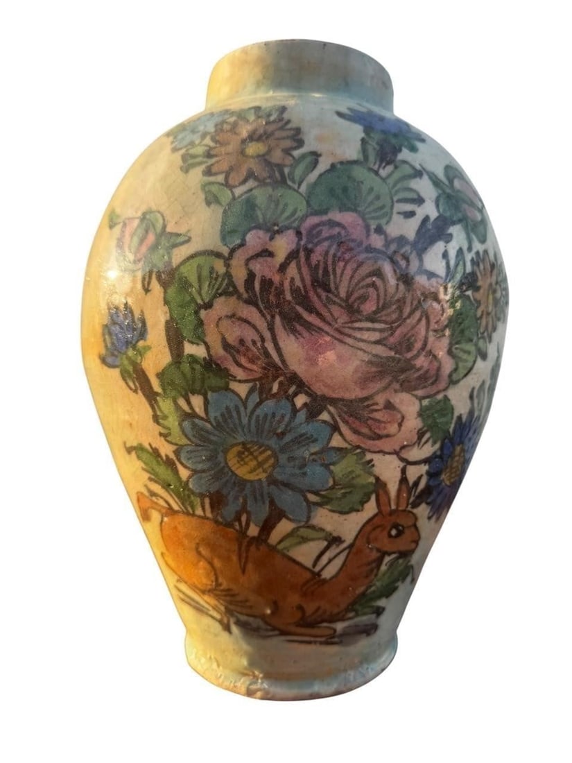 Persian Qajar Dynasty Pottery Vase: Persian Qajar Dynasty hand-painted pottery vase, late 19th century. The ovoid form is decorated with vibrant polychrome enamels depicting blooming roses, daisies, and other floral sprays surrounding