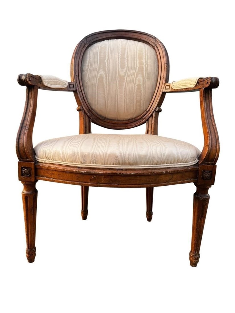 Period Louis XVI Walnut Fauteuil Chair: Period Louis XVI Walnut Fauteuil à Dossier MédaillonFrench, late 18th centuryFine period Louis XVI walnut fauteuil à dossier médaillon, retaining its original hand-carved walnut frame with shaped