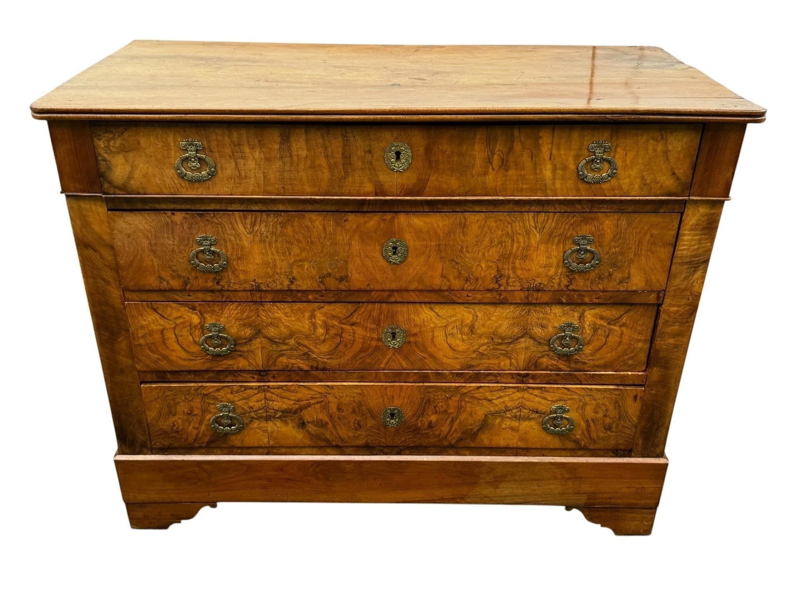 Louis Philippe Walnut Chest 19th c.: Fine period Louis Philippe chest of drawers featuring clean architectural lines, richly figured veneer fronts, and decorative brass hardware. A handsome and highly functional case piece with timeless