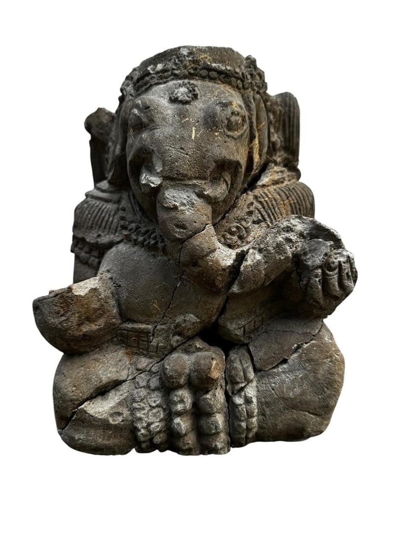Early carved Sandstone Ganesh: Early carved sandstone figural stone sculpture depicting a seated mythical or ceremonial figure with expressive stylized detailing. A decorative sculptural object with strong presence and character.Di