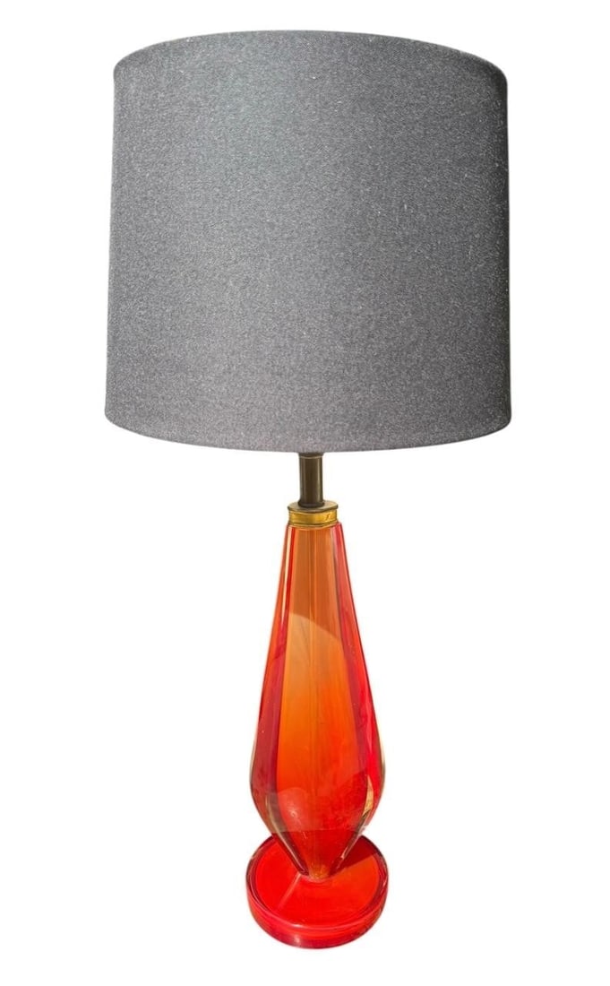 Vintage Red Murano Glass Table Lamp: Vintage Murano Red Glass Table Lamp with Sculptural Tapered Body and Circular BaseStriking vintage Murano glass table lamp featuring a tall, sculptural body in luminous red and orange tones. The elong