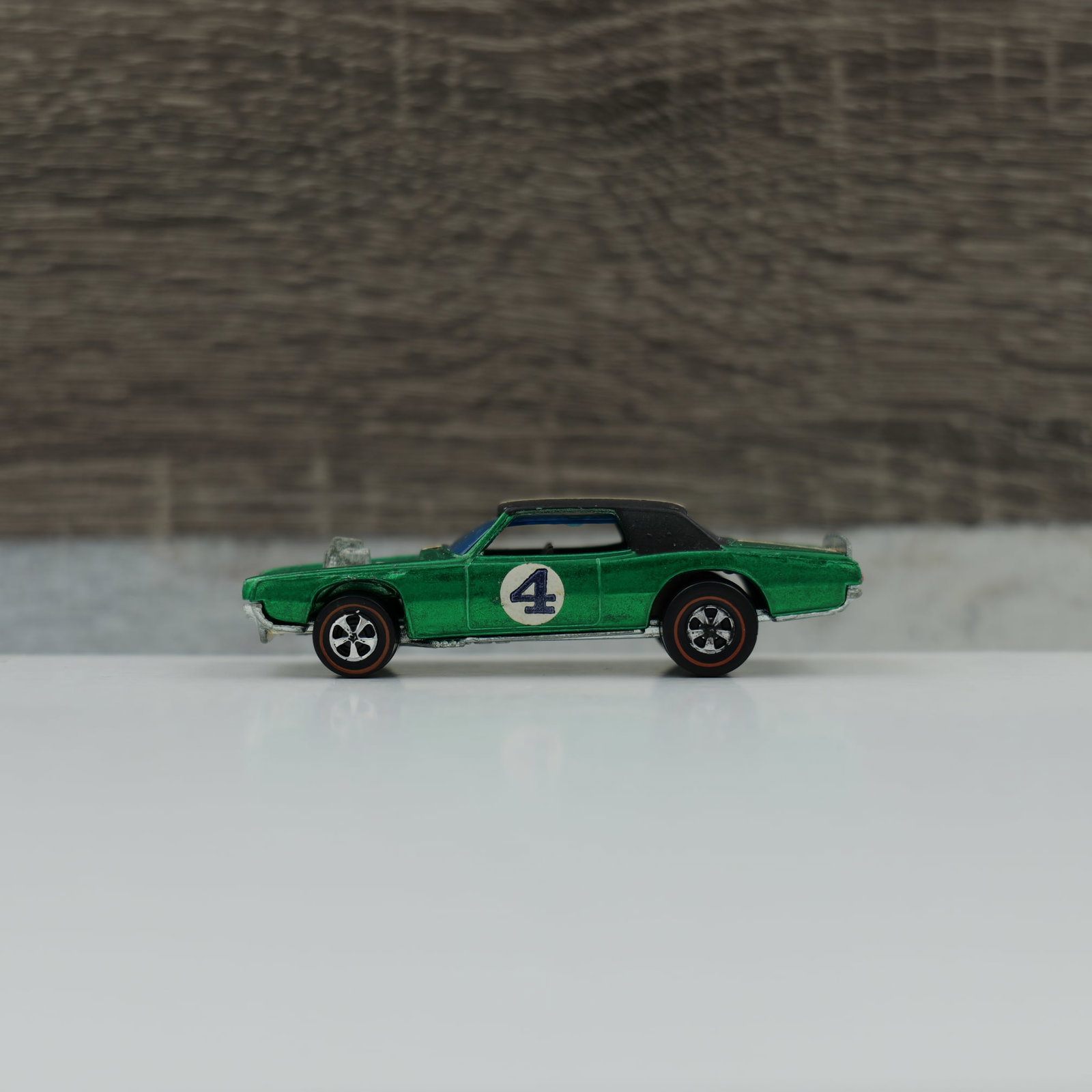 Hot wheels redline "the spoilers" TNT-Bird: TNT-Bird, green, dark interior. Car is blister pull clean. Black roof and stripe are great, paint has light toninhg and little to no wear. Base and engine are brilliant. Grill paint is issing, tailigh