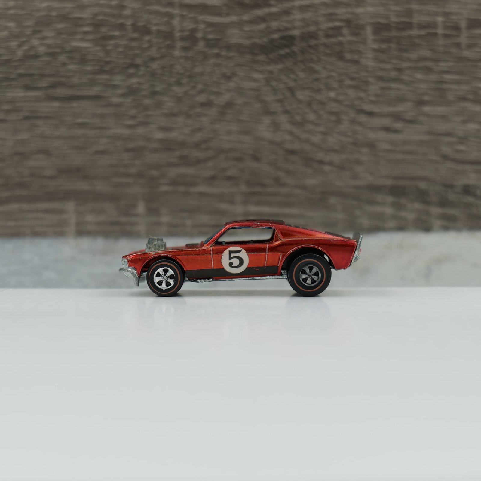 Hot wheels redline "the spoilers" Boss Hoss: Boss Hoss, red, dark interior. Paint is nice and unifrom with little wear. Stripes look origianl. Roundel looks original. Grill and tail paint look good. Engine is toned, base is very shiney.