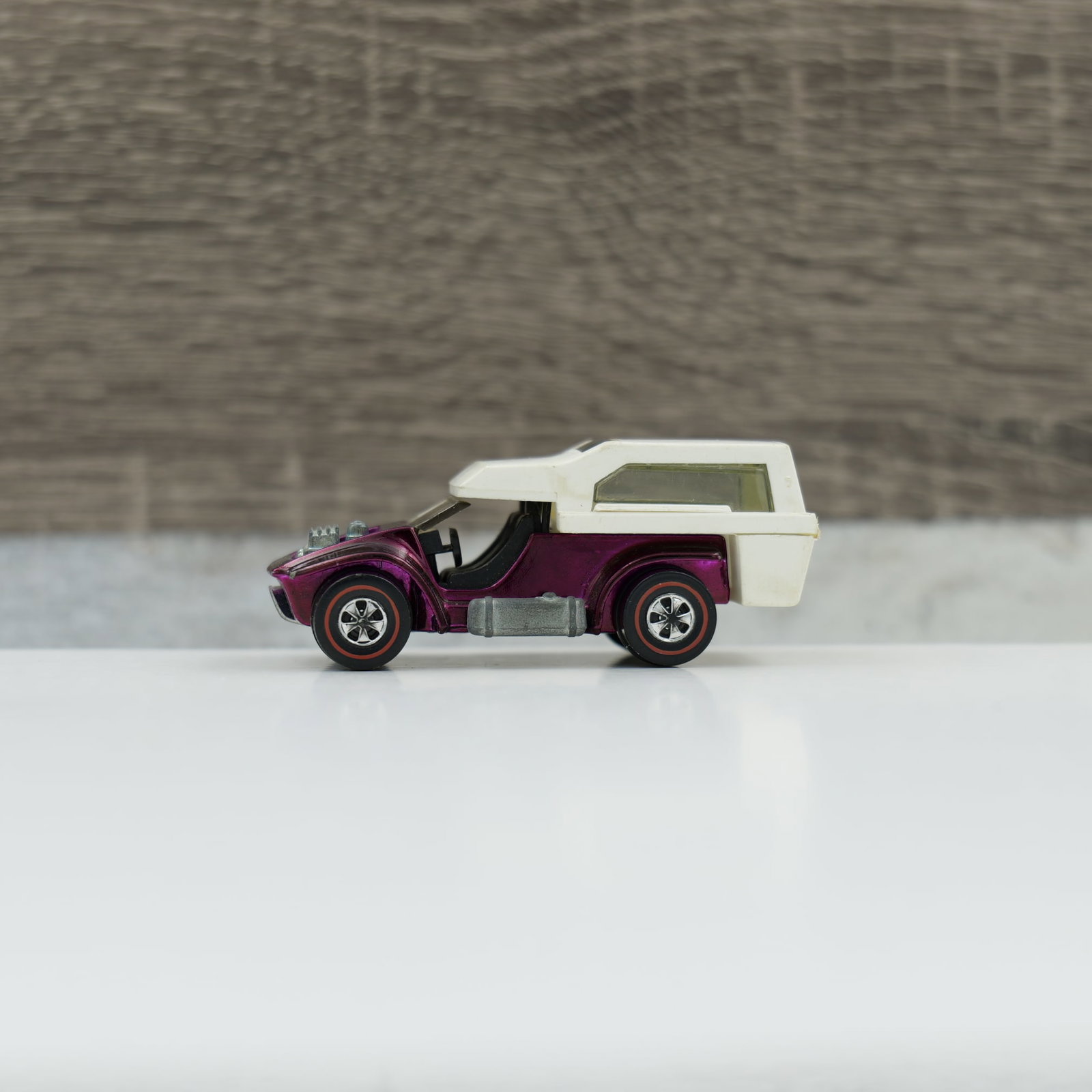 Hot wheels redline power pad: power pad, magenta. Very dark magenta, some toning and very little wear. Roll bar is intact. Topper looks to be original. Base is dull, engine is shiney. Glass, wheels and axles are good.