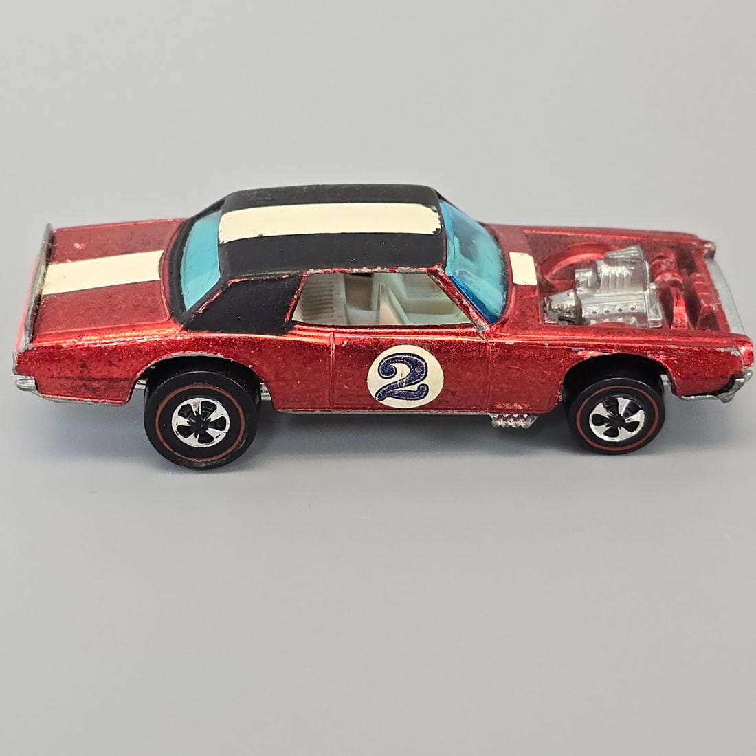 Redline "The Spoilers" TNT Bird: TNT Bird in red with white interior. The glass has no cracks and decals show minor wear. Paint has light toning with minimal wear.