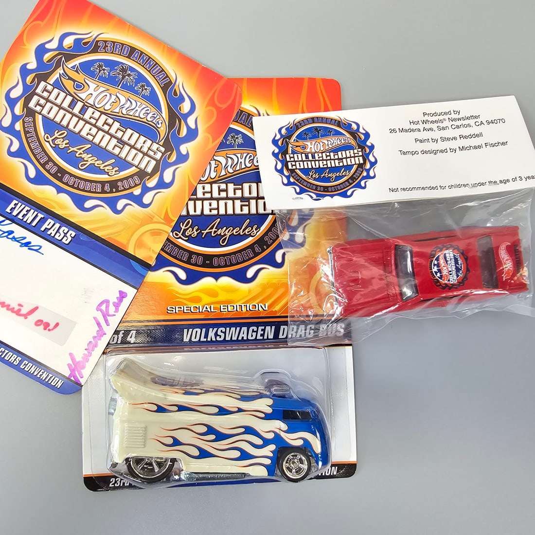 Hot wheels Collector's Convention Lot: Drag Bus, Charity Nova, and Convention Badge. 2009 23rd Annual Collectors Convention Volkswagen Drag Bus 731/3000. Blister looks to be fully attached and clear with no cracks or holes. Card seems to b