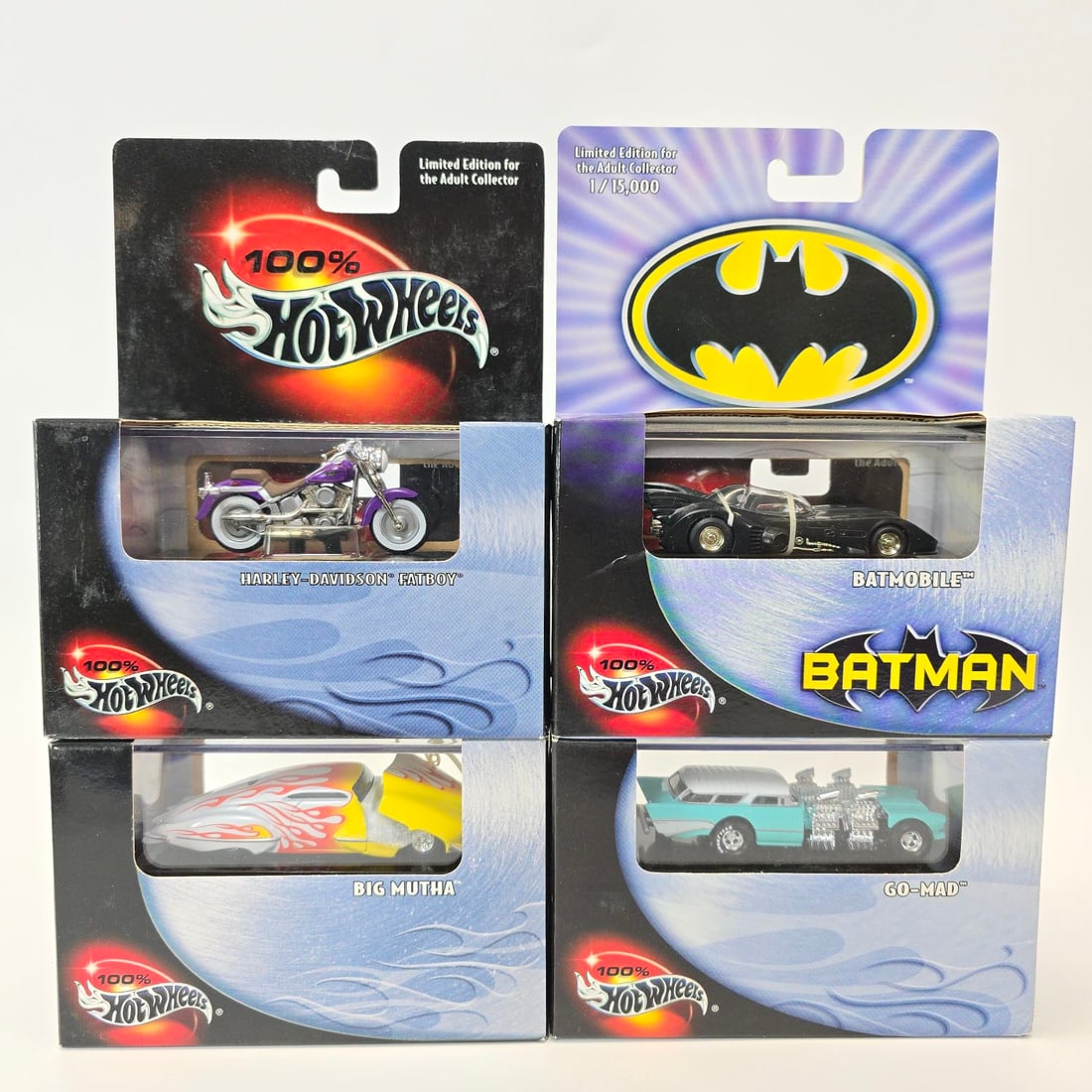 100% Hot Wheels Lot: (4) 100% Hot Wheels cars including (1) Harley Davidson Fatboy, (1) Batmobile, (1) Big Mutha, and (1) Go-Mad. Some light scuffing on box front, but free of any creases, veins, rips, or holes. Windows a