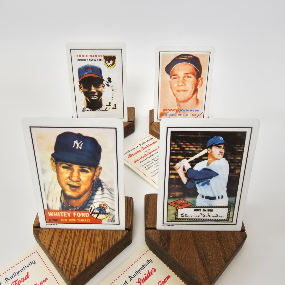 The Hamilton Collection Limited edition Porcelain baseball cards individually numbered with COA: Whitey Ford, Ernie Banks, Brooks Robinson, and Duke Snider all individually numbered with their own COA's , display stands, and boxed in pairs. These all look to be in good condition with no wear or n