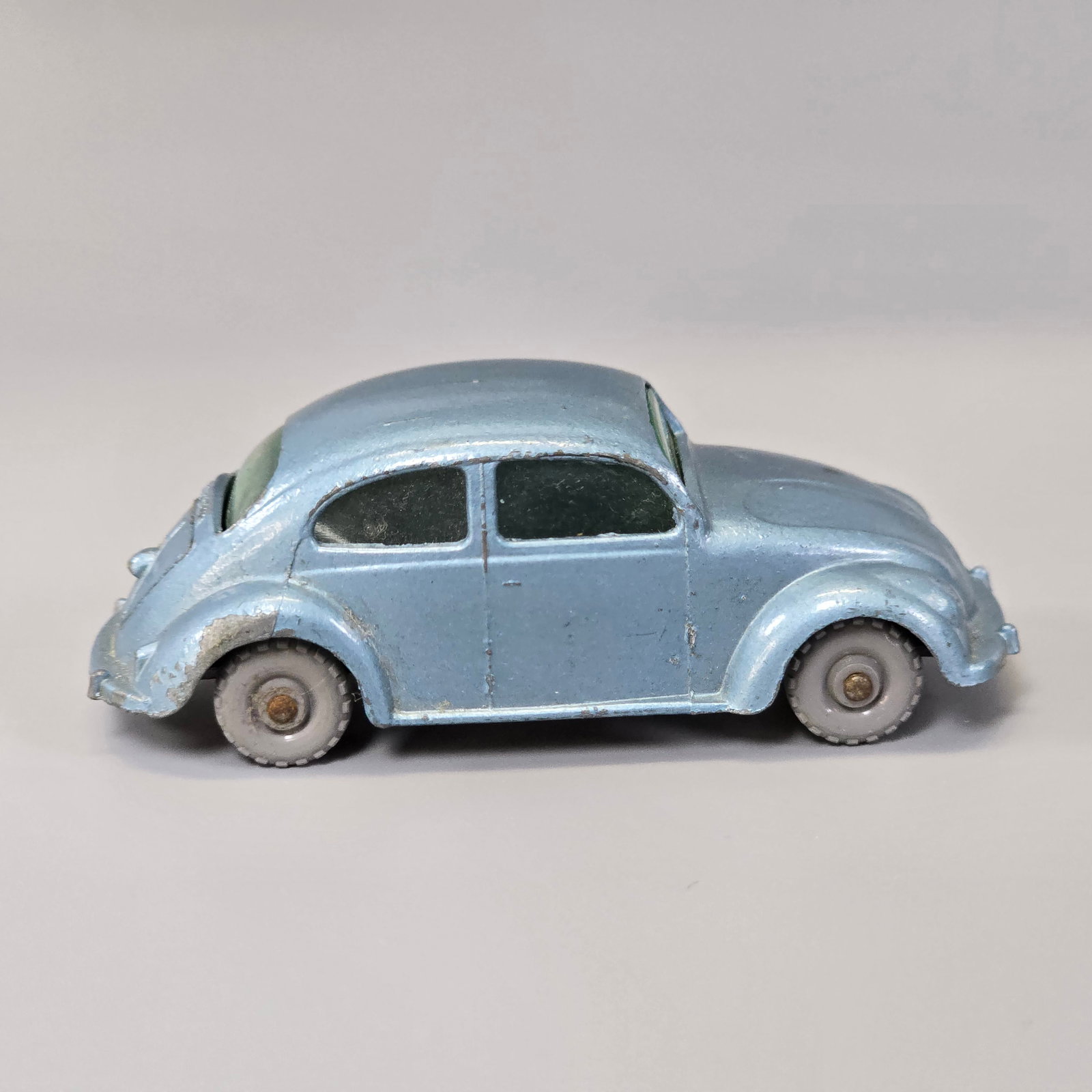 Lesney Matchbox Series Volkswagen: No.25B(2)....Silver/blue body, gray plastic wheels, Green window glass, black base. Opening hood works and is intact. There is some light play wear and notably a rub of , missing paint at the passenge