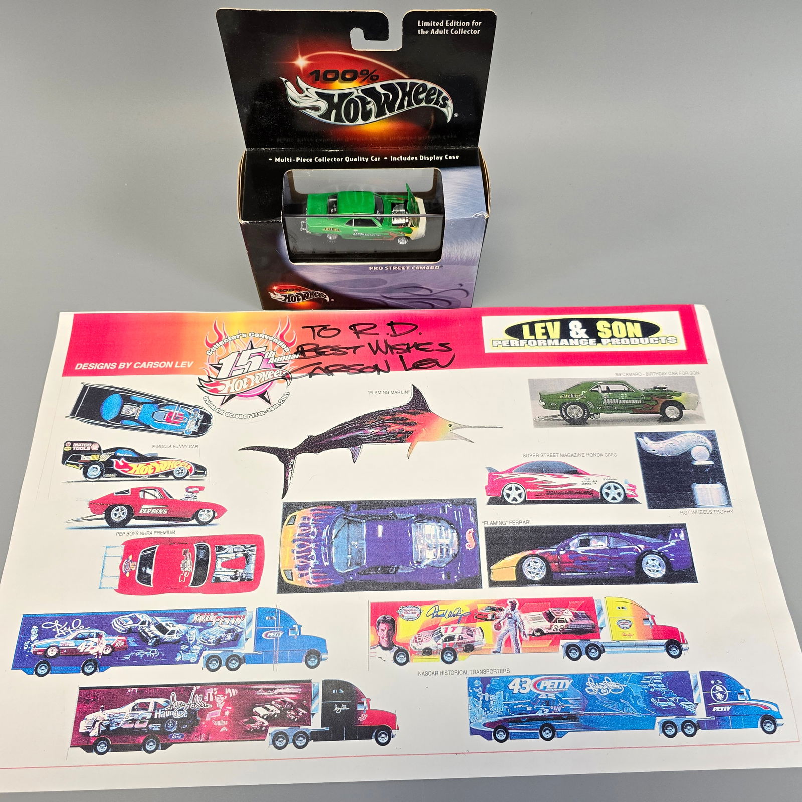 100% Hot Wheels Pro Street Camaro and signed sheet: Includes: 100% Hot Wheels Black Box Pro Street Camaro and design sheet signed by Carson Lev Box: very good with a dinged corner as shown in the photos Blister/Bubble