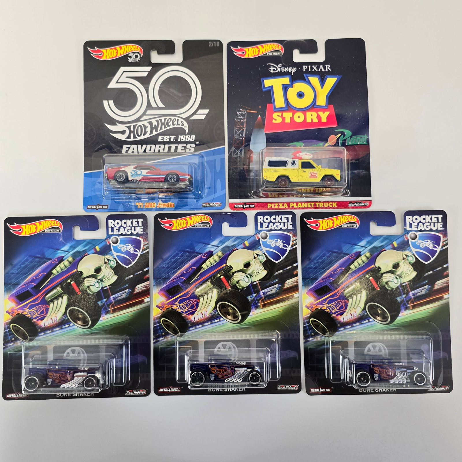 Hot Wheels Entertainment Lot: Hot Wheels Entertainment lot of 5 cars including, (3) Rocket League Bone Shakers, Toy Story Pizza Planet Truck and '71 AMC Javelin Cards: Very Good to Excellent with minor wave and edgewear in spots a