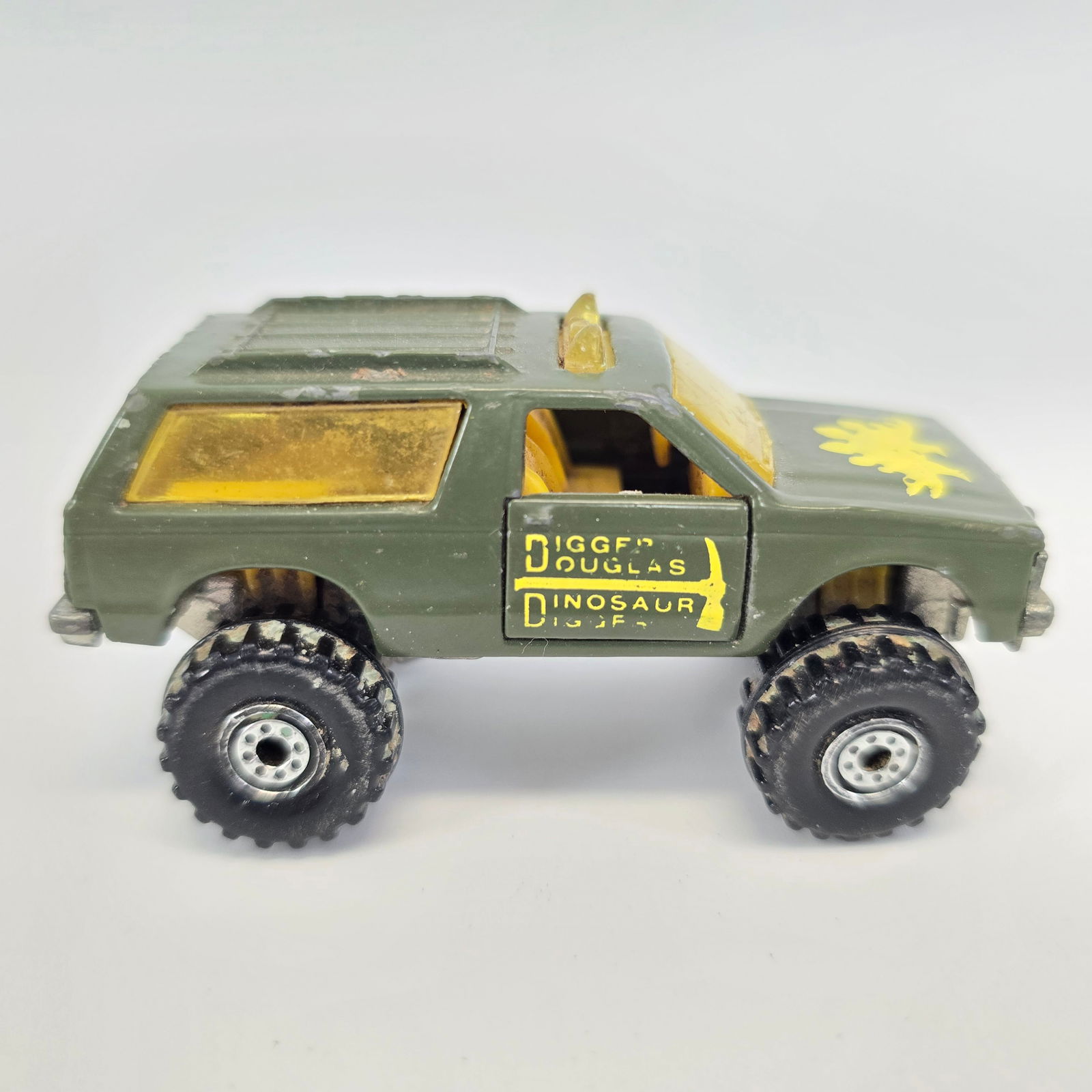 Hot Wheels Blazer 4x4: Hot Wheels Blazer 4x4 with Digger Douglas Dinosaur Digger Tampos Condition; used with some edgewear, material in tire tread, worn tampos on passenger side