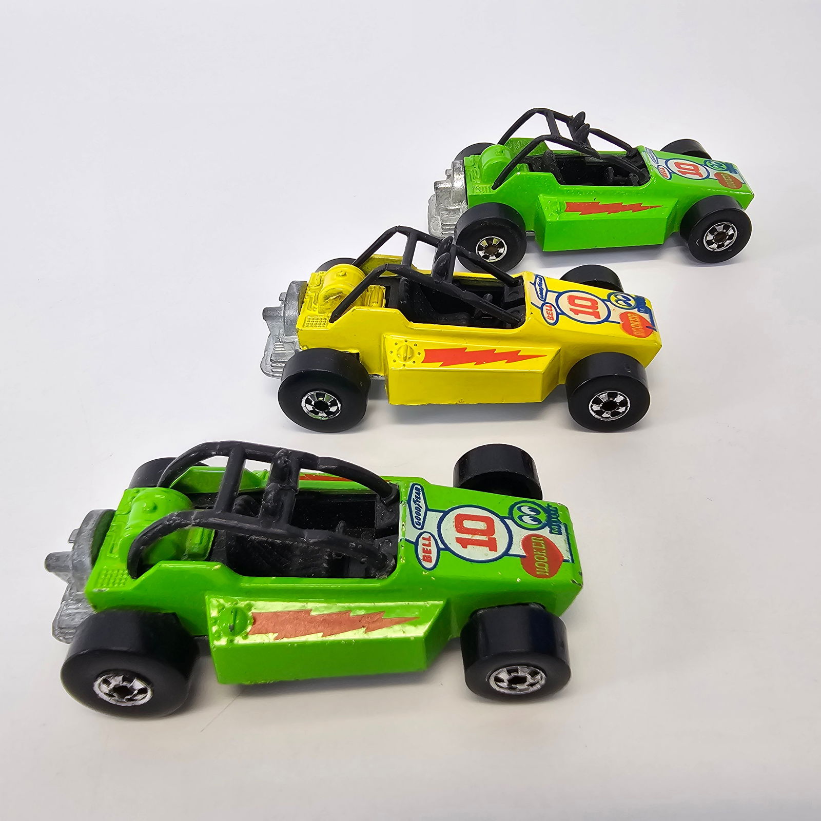 Hot Wheels Lot of 3 Rock Busters: Hot Wheels Lot of 3 Rock Busters including 2 green and 1 yellow with one Hong Kong green and one Malaysia base Condition; All cars seem to be good with minimal wear and no notable damage
