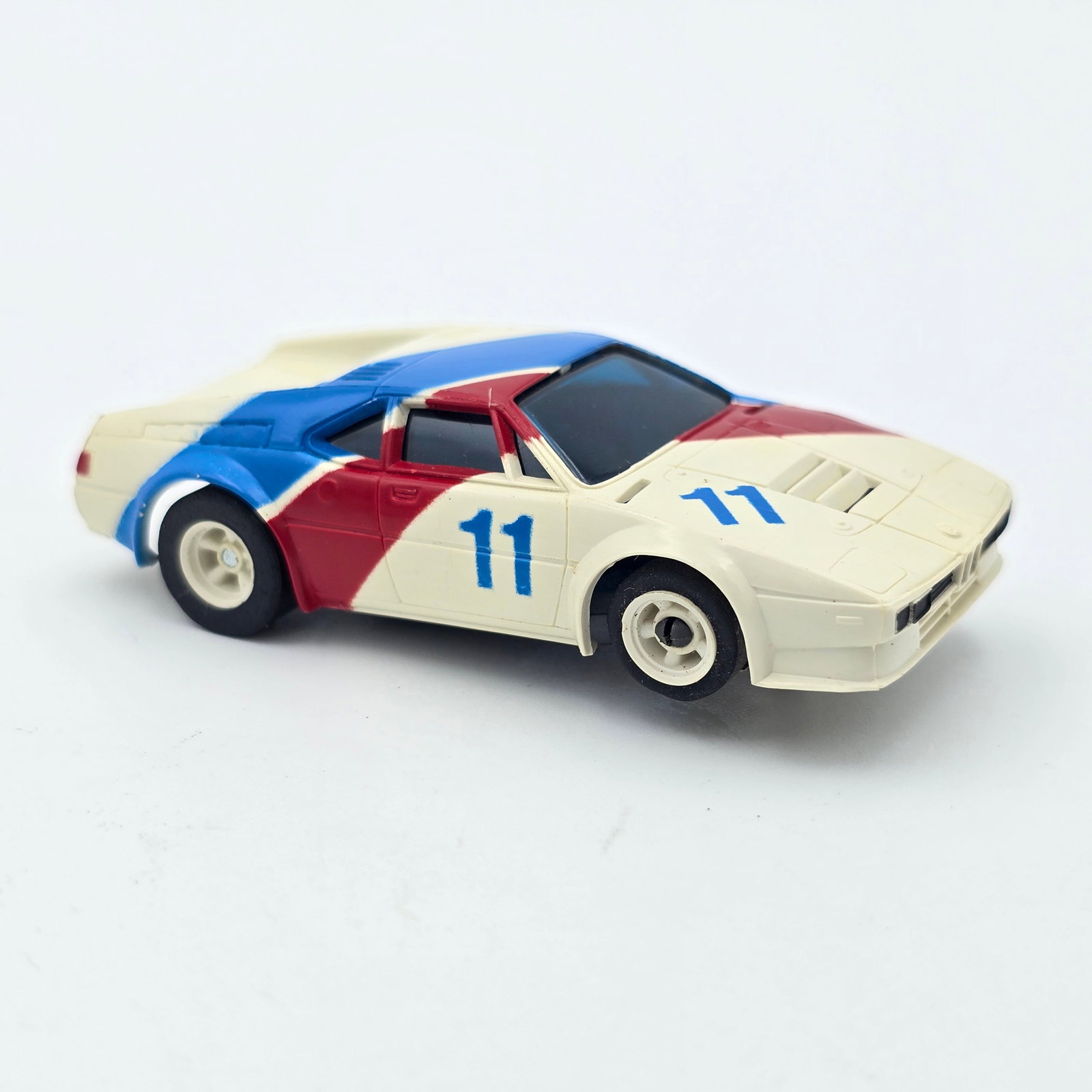 Aurora AFX BMW M1 Slot Car: Aurora AFX BMW M1 Slot Car Car looks to be in good condition and complete with no issues of note, shows light play wear to pick up shoes as seen