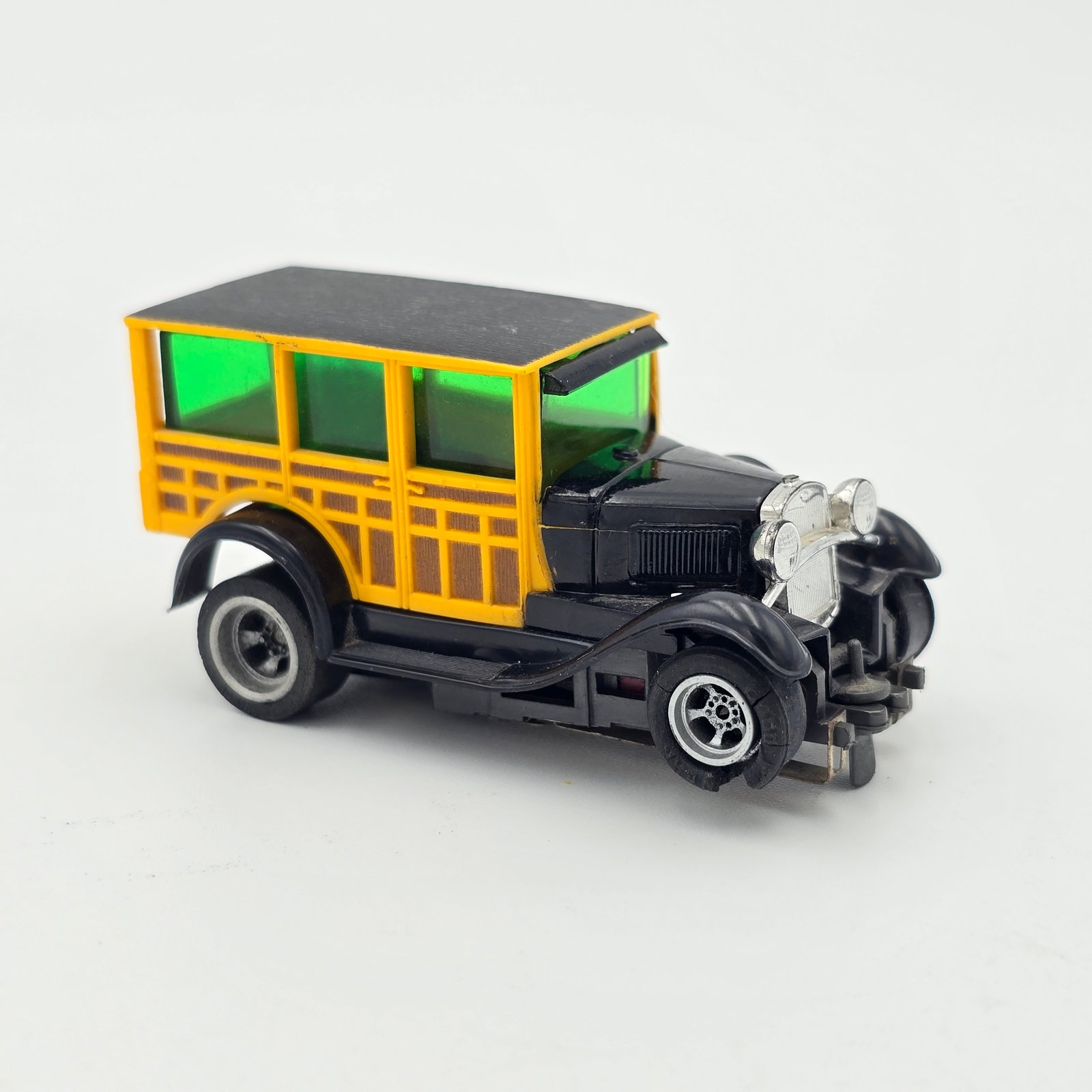 Aurora AFX Ford Woody HO Slot Car: Aurora AFX Ford Woody HO Slot Car Car- Looks to be in good condition and complete with no issues of note aside from the split front tire rubber as seen, pickup shoes show a touch of wear