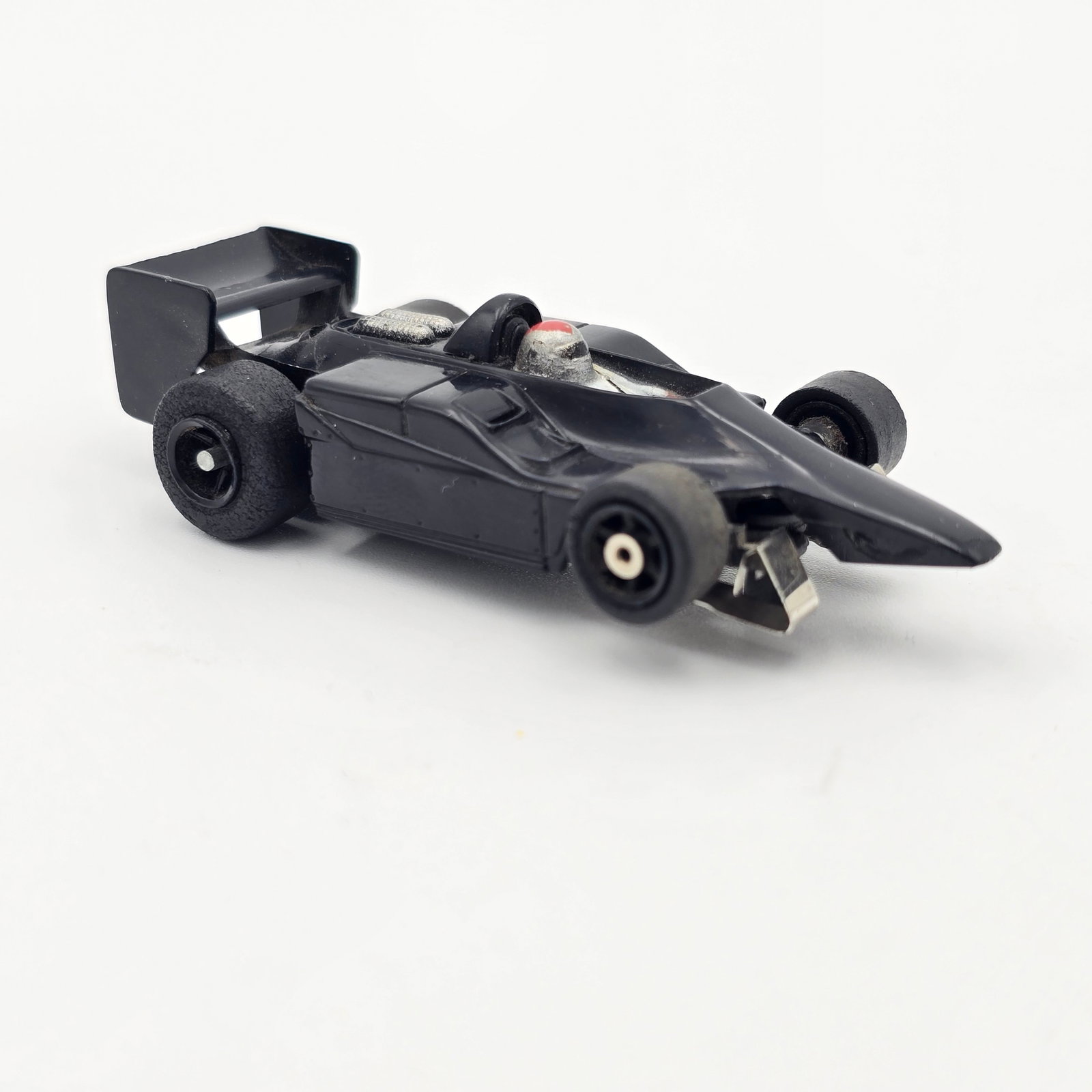 Aurora AFX G-Plus Lotus F1 Slot Car: Aurora AFX G-Plus Mario Andretti Lotus F1 Slot Car Car is fair as it is missing its front ground effects, all of its decals and rear rubbers are dry rotted