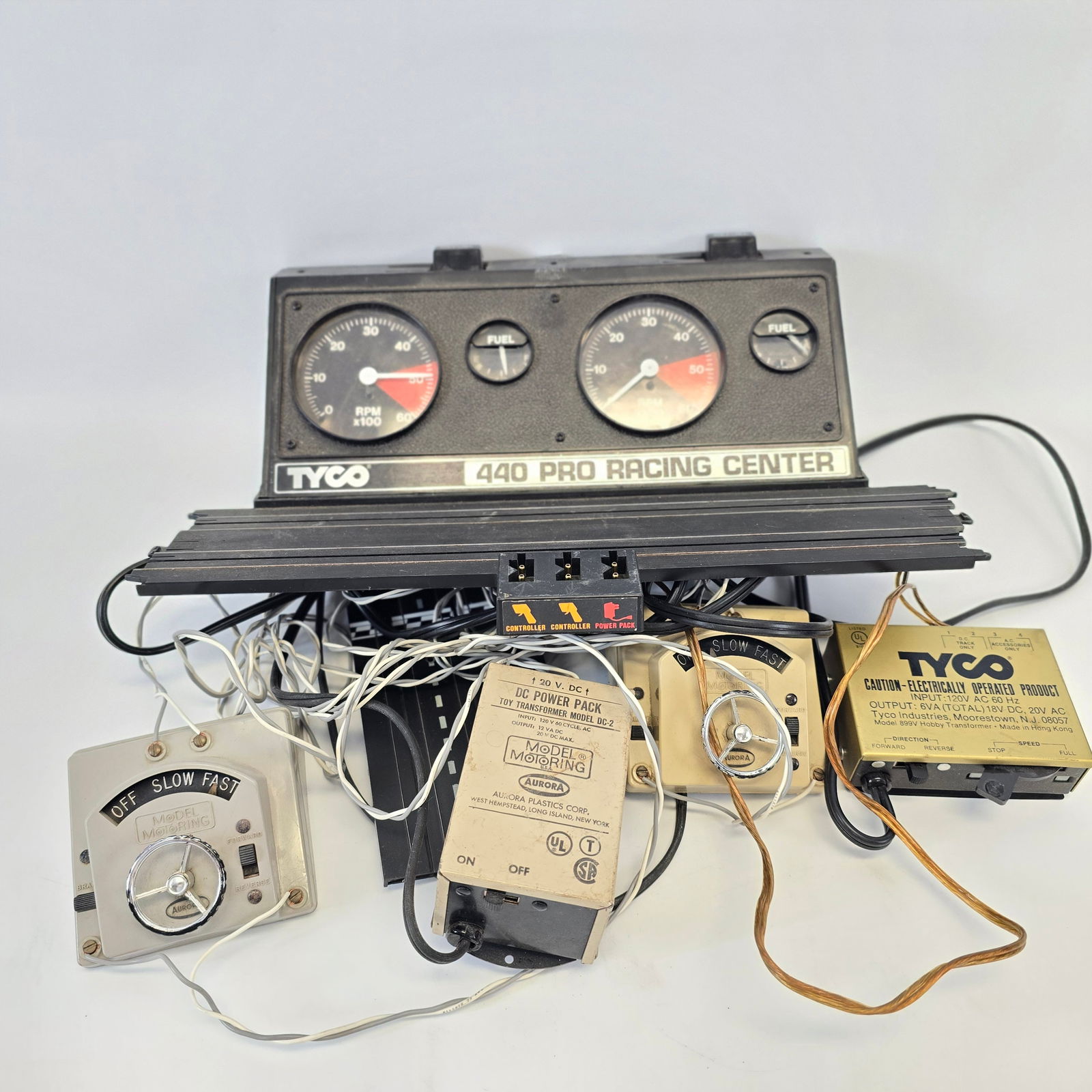 Assorted Slot Car Track: Tyco 440 Pro Racing Center Includes 2 power packs, 2 steering wheel controllers Used and looks to be missing parts, untested