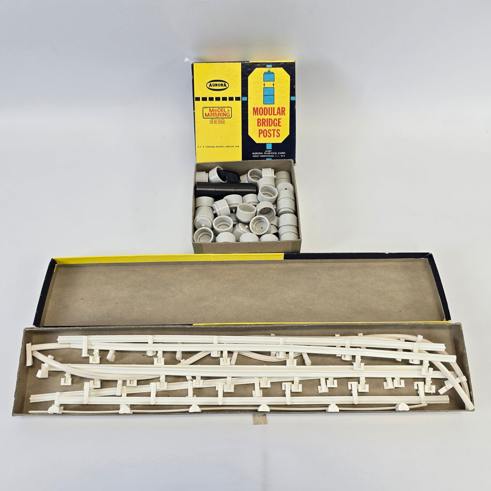 Aurora Model Motoring Accessories: Aurora Model Motoring Accessories Includes a box of modular bridge pieces and a box of guardrails Both look to be near complete but used
