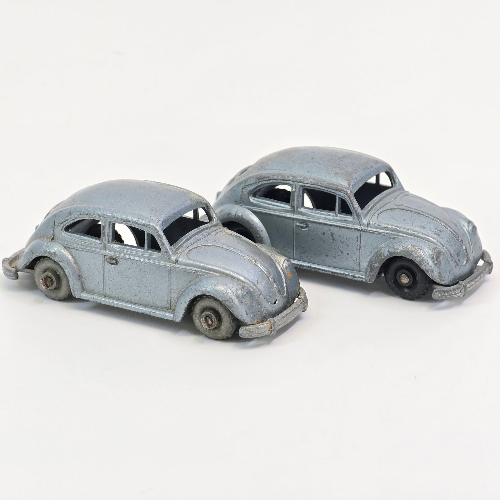 Budgie VW's: Budgie Models VW Beetle No. 8 pair One with black plastic wheels and one with metal wheels. Both show play wear about however the metal wheels car is in much better condition with lighter wear. Both c