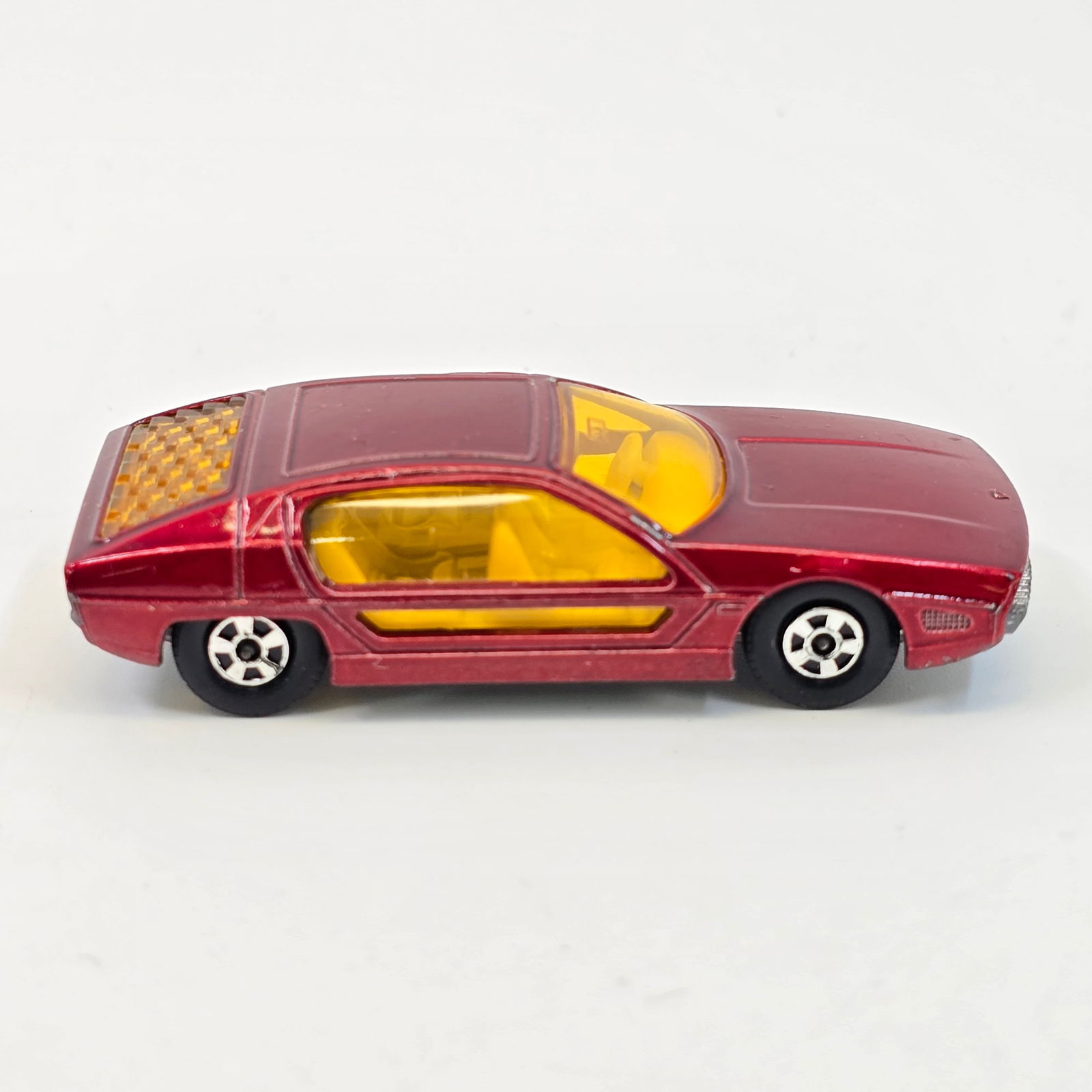 Lesney Matchbox SuperFast Marzal: Lesney Matchbox Superfast LS 20-A LAMBORGHINI MARZAL Metallic red body, amber windows, unpainted base, curved hood line. Model appears in good condition showing little to no wear. 