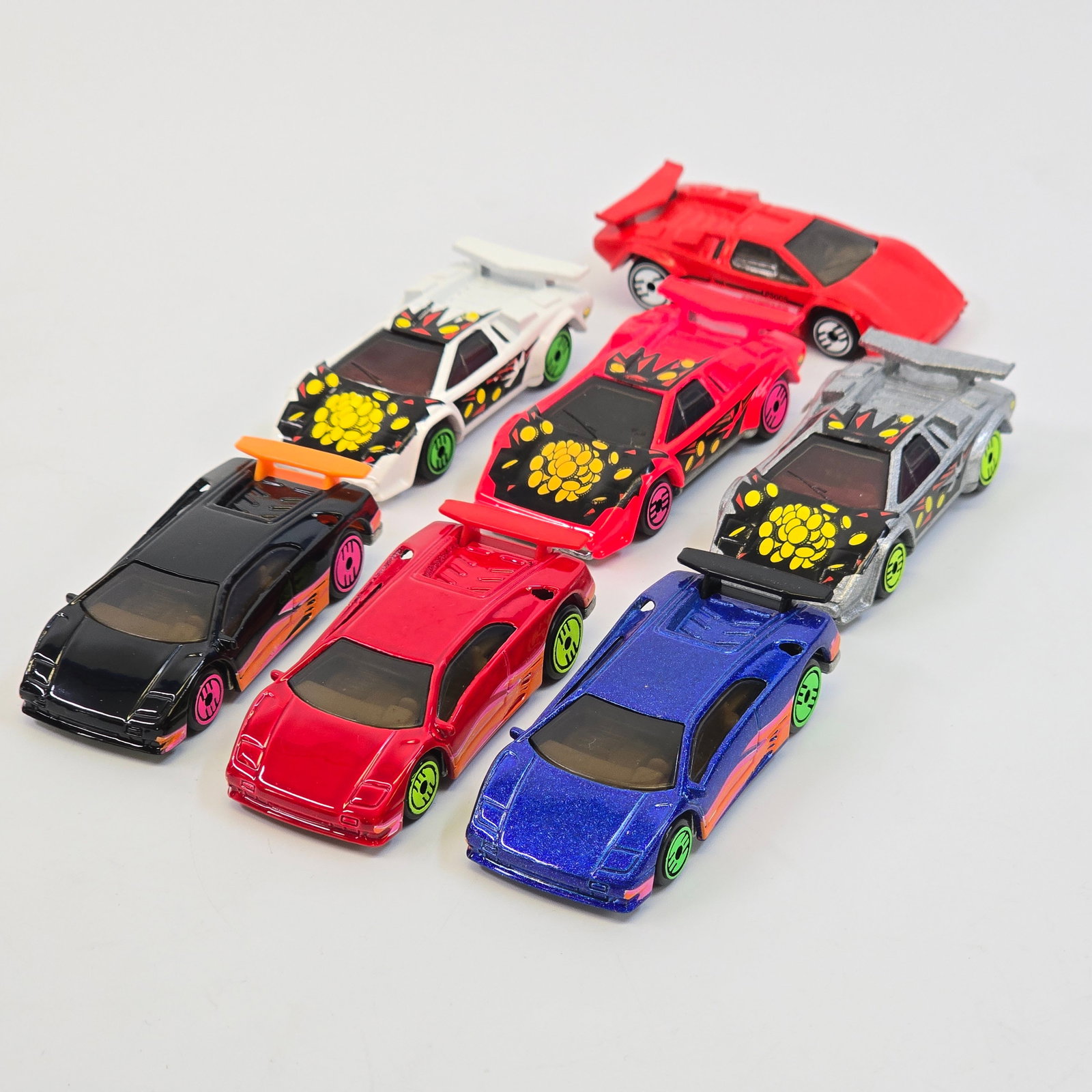 Hot Wheels Lamborghini Lot: Lot of (7) Hot Wheels Lamborghinis including: 1- 1993 Countach Mainline 2- (3) 1993 Revealers Series Countach, (1) Metallic Silver (1) Bright Pink (1) White 2- (3) 1993 Revealers Series Diablo, (1) Re