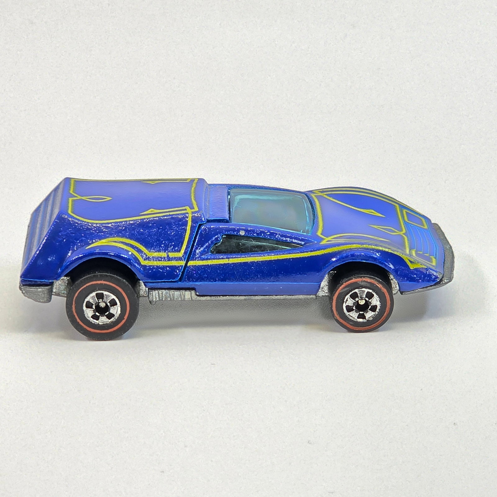 Hot Wheels Redline Buzz Off: Buzz Off - Blue - yellow script tampos Excellent condition overall with a few scattered micros, mainly at front passenger corner as seen, appears unplayed with. Crisp, clean tampos. Glass is crack fre