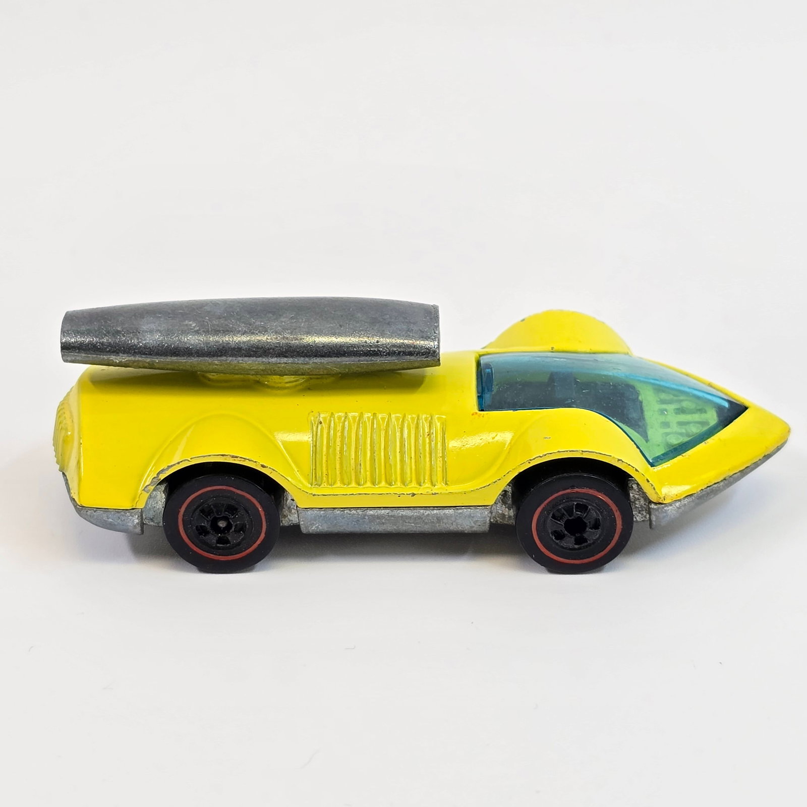 Hot Wheels Redline Rocket Bye Baby: Enamel Rocket Bye Baby -Yellow - Dark interior Very good condition overall, has some hard edge wear at nose and on some fender edges as seen. Glass is crack free. Wheel chrome is mostly absent all aro