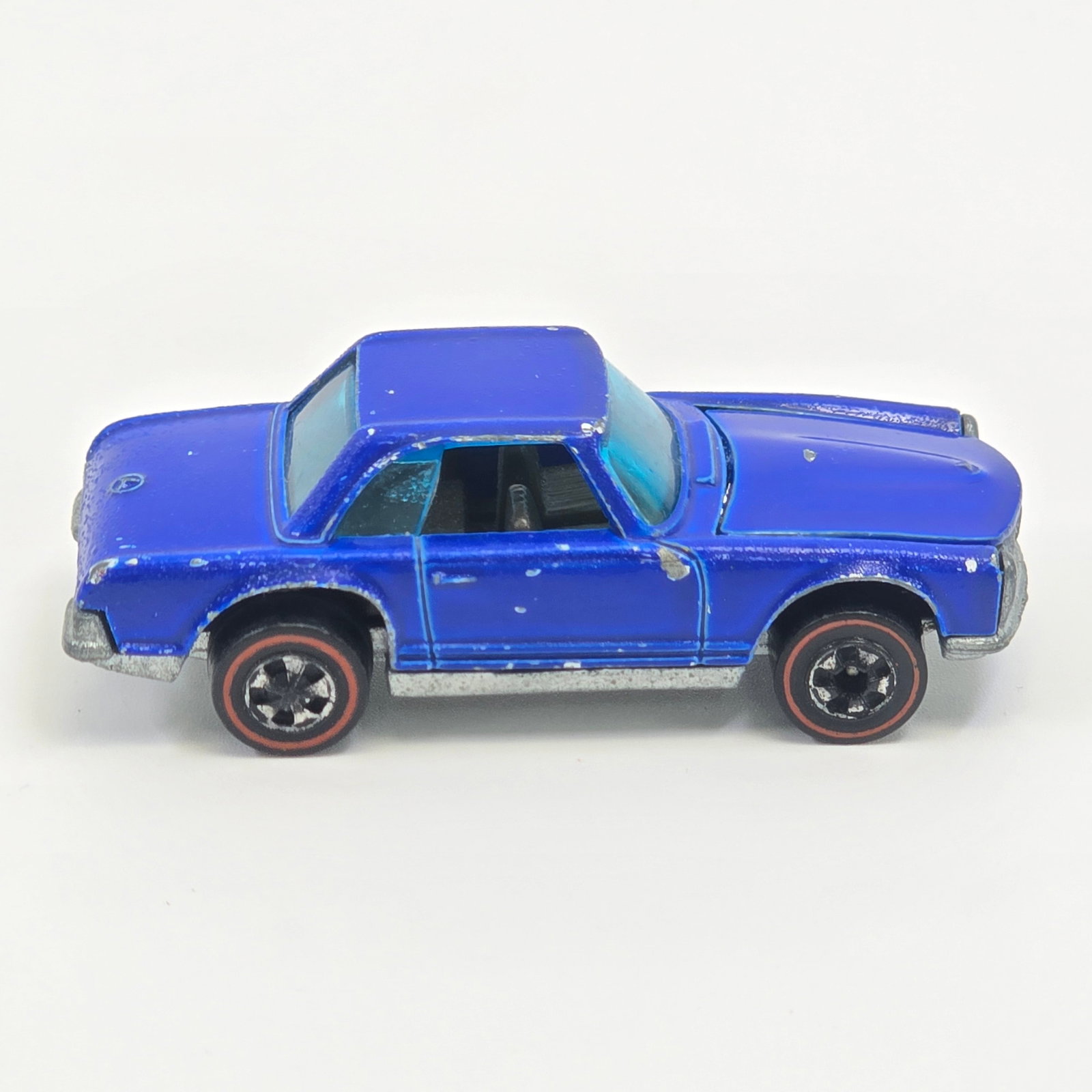 Hot Wheels Redline Mercedes 280sl: Enamel Mercedes 280sl - Dark Blue - Dark interior Fair condition, has scattered chips and hard edge wear throughout as seen. Good glass. Wheel chrome is fair with wear as seen. Base is very good.