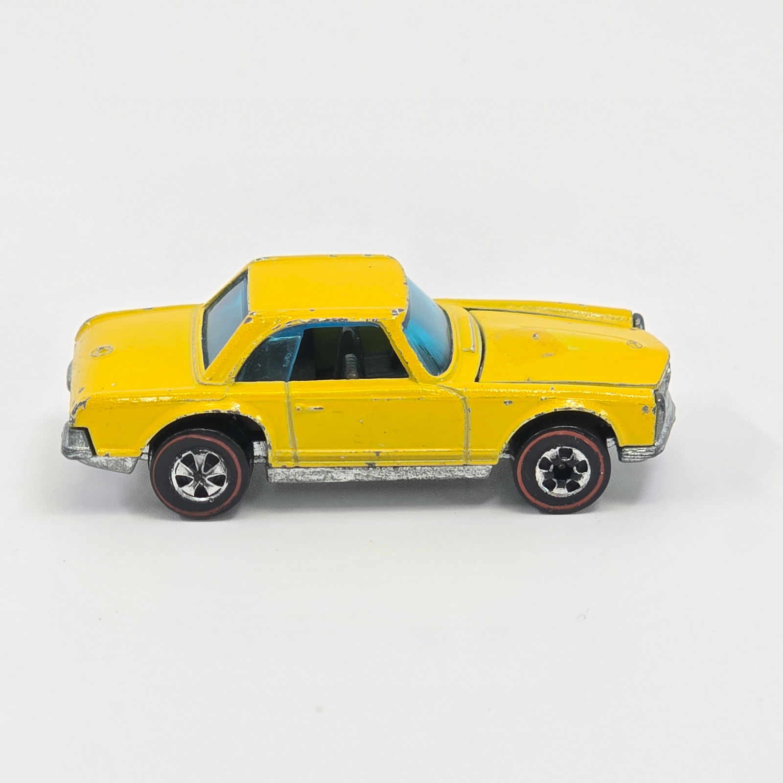 Hot Wheels Redline Mercedes 280sl: Enamel Mercedes 280sl - Yellow - Dark interior Fair condition, has scattered chips and hard edge wear throughout as seen, does have a largish touch up on hood as shown. Good glass. Wheel chrome is go