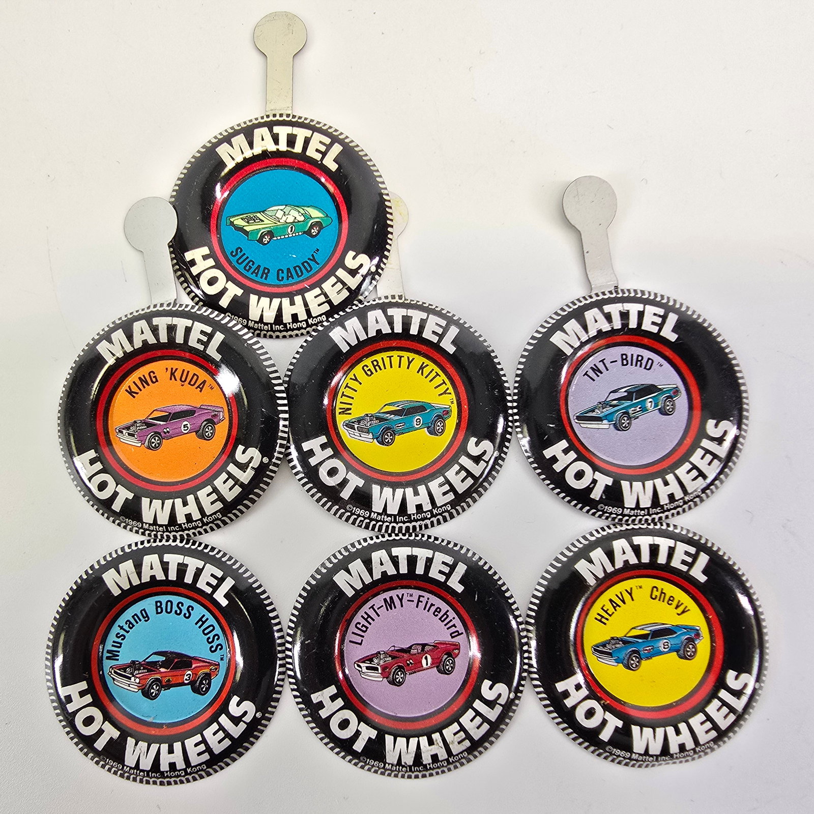 Hot Wheels Redline "The Spoilers" buttons: Hot Wheels Redline "The Spoilers" buttons Includes 7 different "The Spoilers" buttons, all are in very good condition or better, may have light scuffs or scratches in spots, backs 