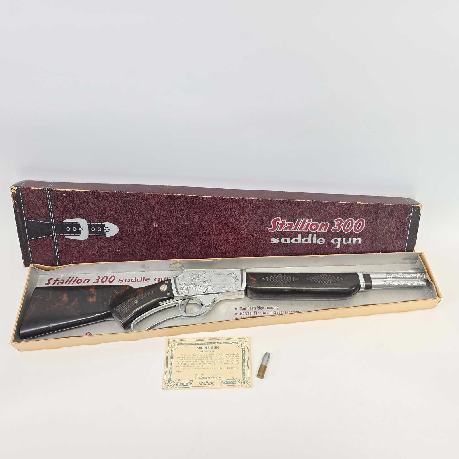 1950s Era Nichols Toy Rifle: 1950s Nichols Industries Inc. - Jacksonville, TX. Made! - Stallion 300 Saddle Gun, Toy Rifle - Original cardboard box w/illustrated lid - 27.5" long die-cast and plastic rifle w/Nichols info card