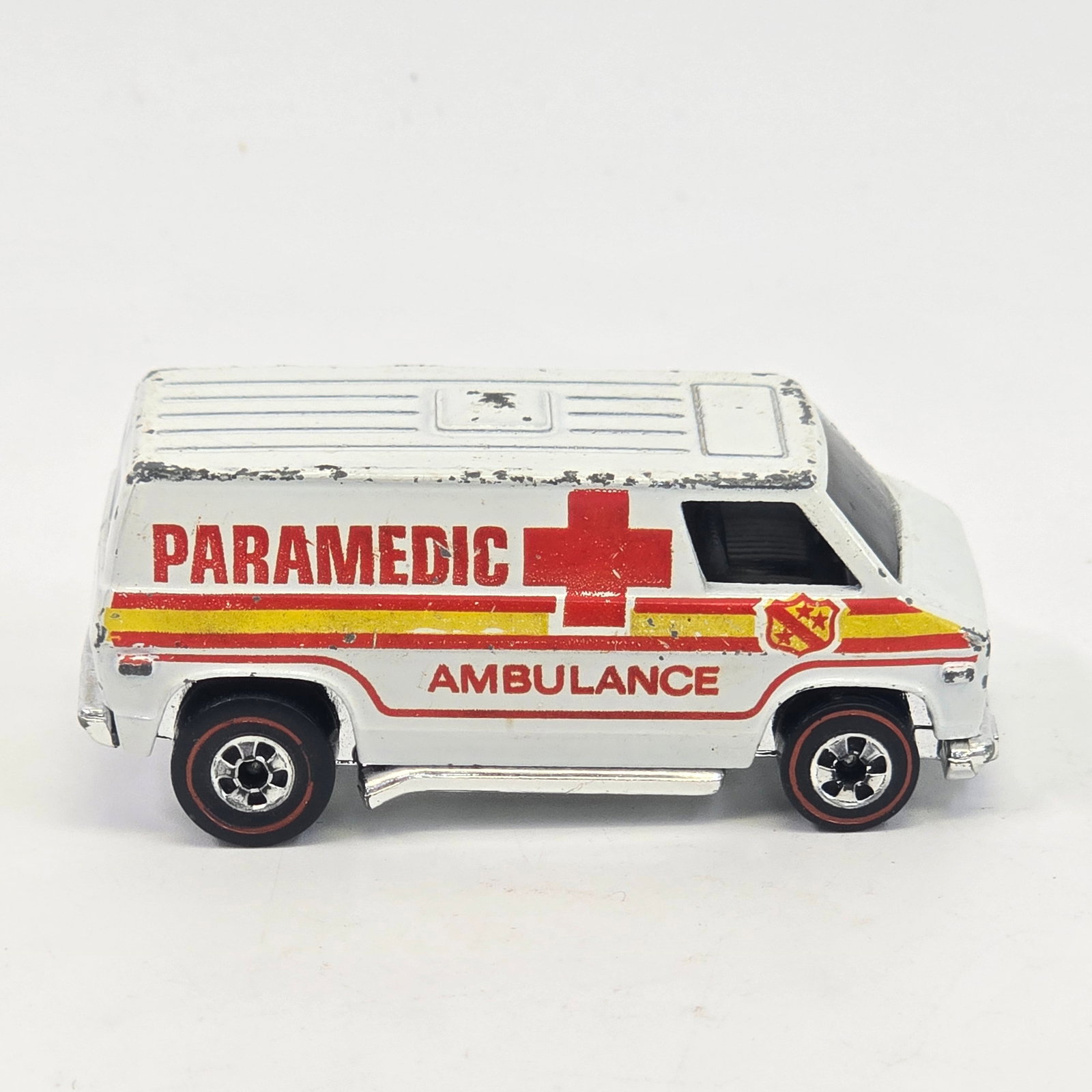 Hot Wheels Redline Ambulance: Hot Wheels Redline White Enamel Ambulance Paint: Good with chips and hard edge wear as seen Tampos: Very good with some chipping and light wear as seen Wheel Chrome: Excellent Glass: Excellent Base: E